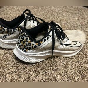 Cheetah and white nike tennis shoes